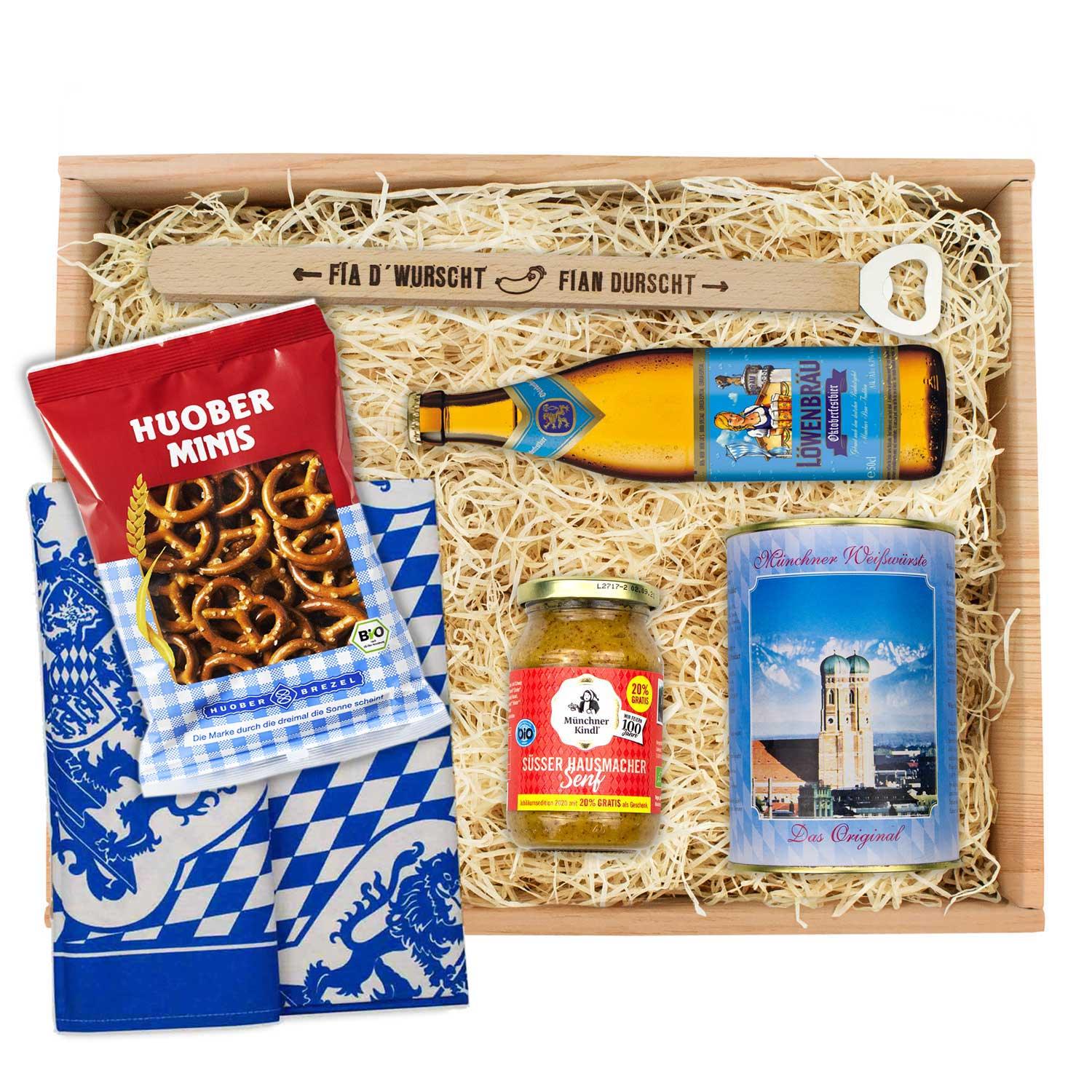 Oktoberfest-Box mit vier hellen Weißwürsten, goldbraunen Brezn, süßem Senf und wählbarem Wiesn-Bier.
