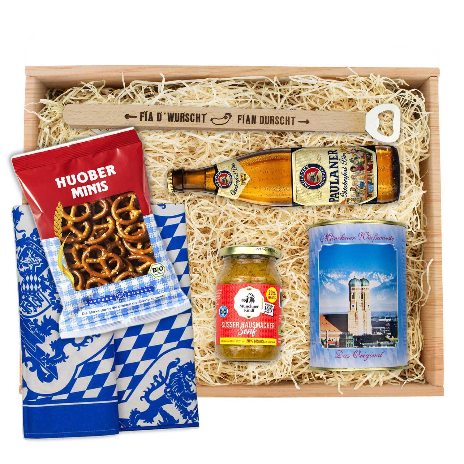 Oktoberfest-Box mit vier Weißwürsten, süßem Senf, zwei Laugenbrezn und einer Oktoberfest-Bierflasche.