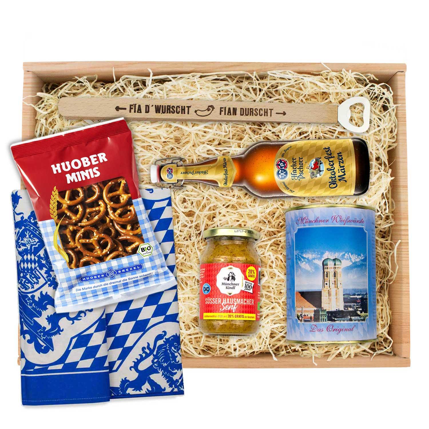 Oktoberfest-Box mit vier hellen Weißwürsten, zwei Brezn, süßem Senf und einer Flasche Oktoberfestbier.