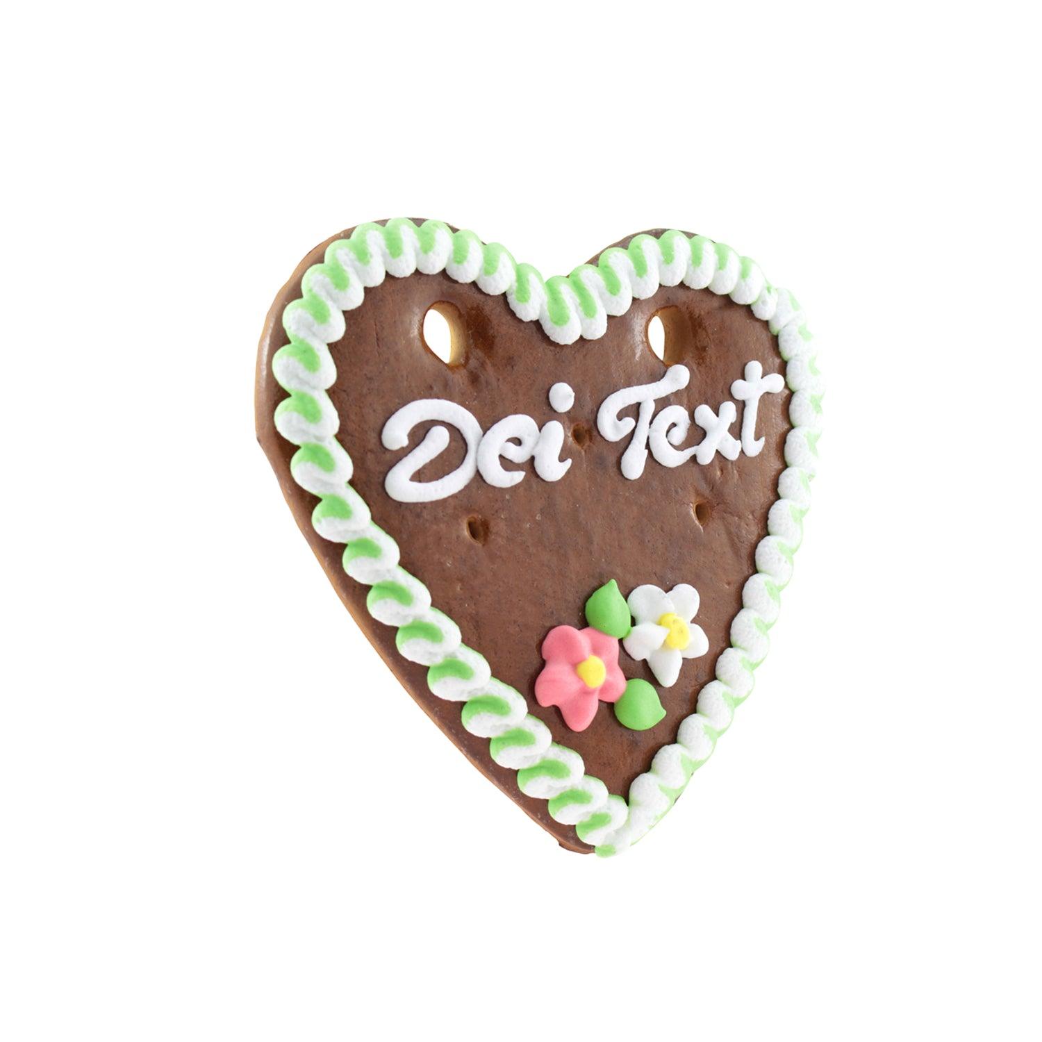 Herzförmiges Lebkuchenherz mit blauer Zuckerdekoration, weißem Schriftzug und roten Zuckerrosen, ca. 13 x 14 cm.
