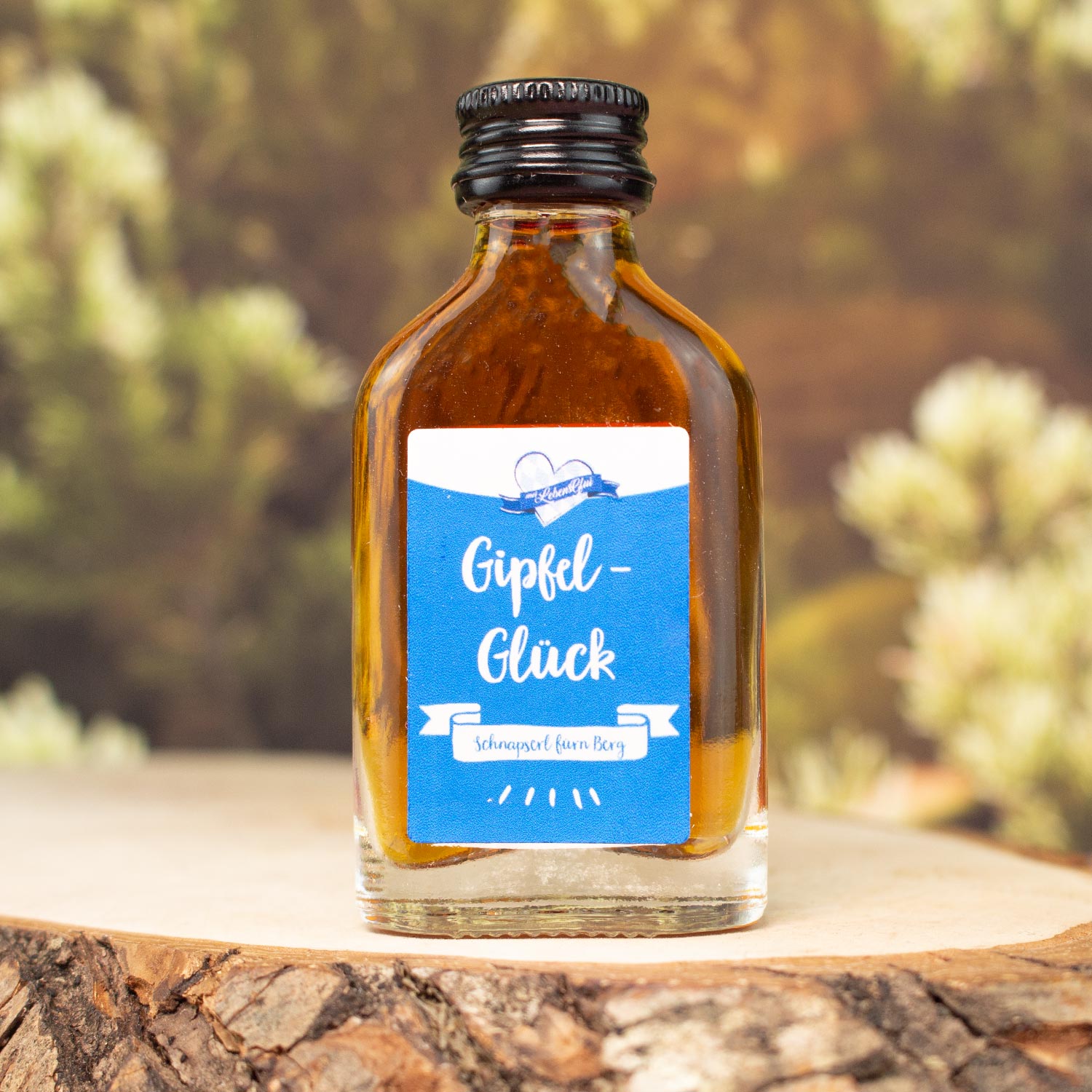 Kräuterlikör mit 30 % vol. in kleiner Glasflasche, Motiv „Gipfel-Glück“, rot-weißer Verschluss, 20 ml Inhalt