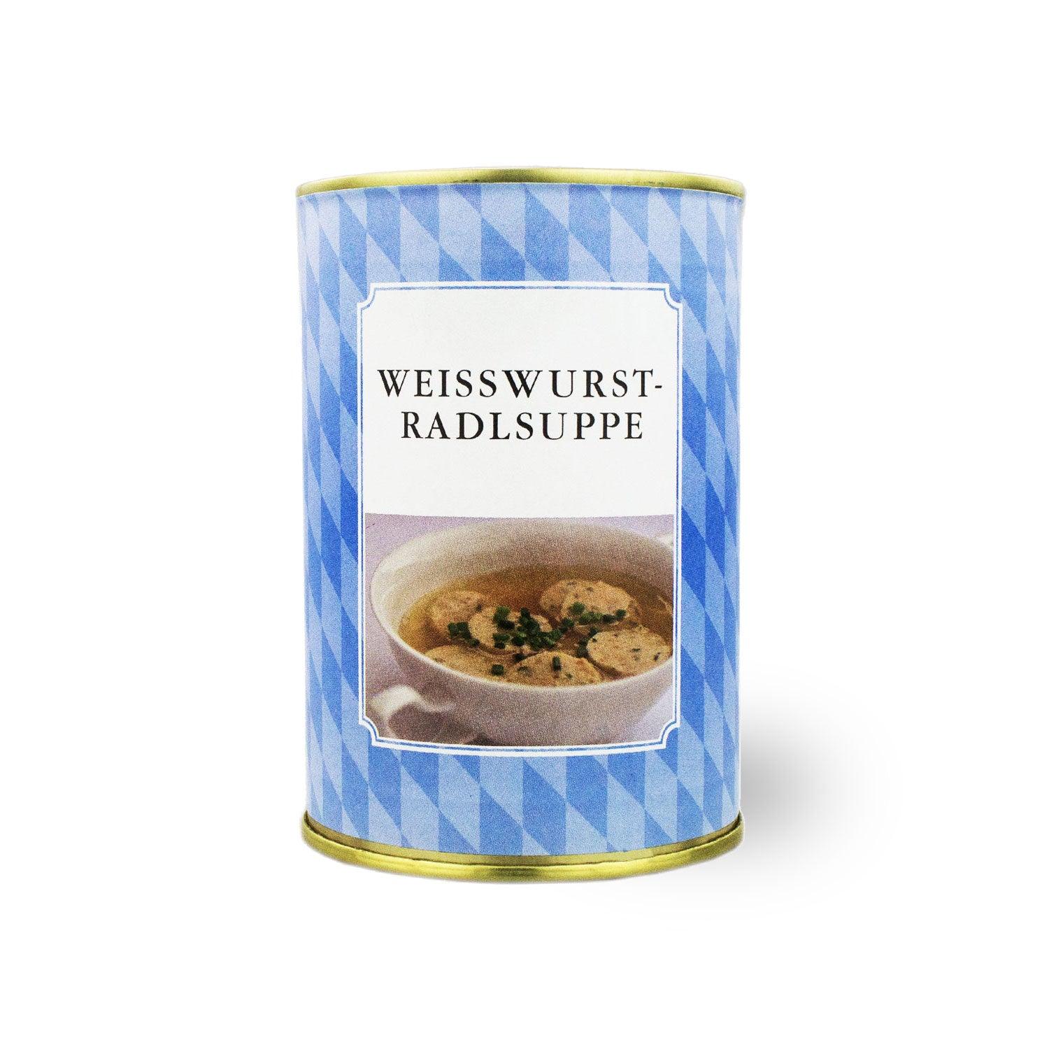 Bayerische Geschenkbox mit Weißwurschtradl-Suppe, Weißwurst-Nudeln und Wurstzange mit Schriftzug.